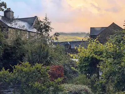 a painting of a garden in front of houses at Y Swdio, Ferm Glandwr in Barmouth