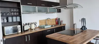 a kitchen with a wooden counter top with a sink at Beautiful Seafront 1 bedroomed apartment in Aberystwyth