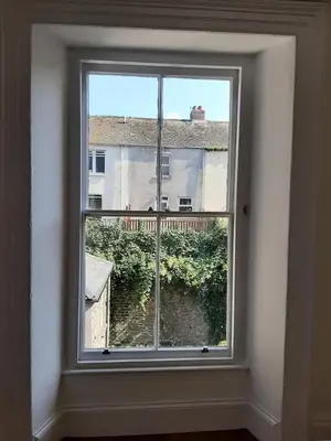 a window in a room with a view of a building at Beautiful Seafront 1 bedroomed apartment in Aberystwyth
