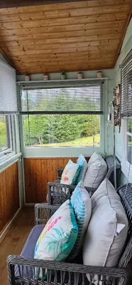 a room with two beds and a window in a rv at Log cabin - free parking garden & pet friendly in Trawsfynydd