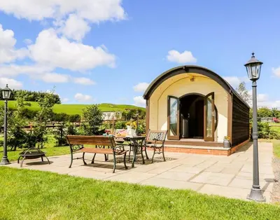 a gazebo with a table and chairs in a park at Meadow View in Rhayader
