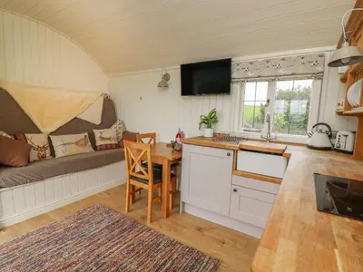 a kitchen with a table and a couch in a room at Hillside View in Rhayader