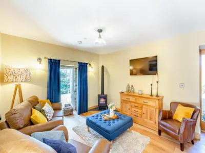 a living room with a couch and chairs at The Mill in Llandegley