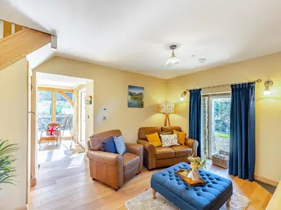 a living room with a couch and a chair at The Mill in Llandegley