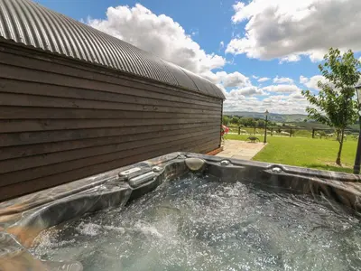 a pool of water in front of a building at Valley View Pod in Rhayader