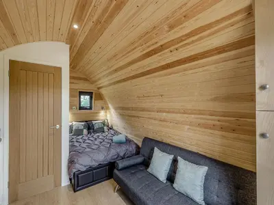 a bedroom with a bed and a couch at Beech Uk36260 in Llanfair Caereinion