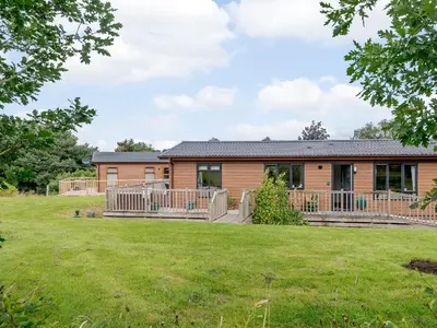 a house with a large yard in front of it at Bryn Teg - Cottage in Maesmynis