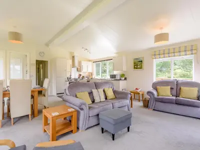 a living room with two chairs and a couch at Bryn Teg - Cottage in Maesmynis