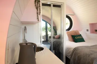 a small room with a bed and a mirror at Celyn in Welshpool