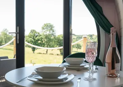 a table with two plates and a glass of wine at Celyn in Welshpool