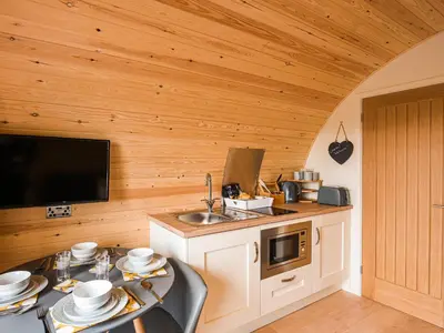 a kitchen with a sink and a microwave at Cae Bitfel - Cottage in Llanwddyn
