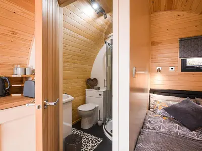 a small bathroom with a toilet and a sink at Cae Bitfel - Cottage in Llanwddyn