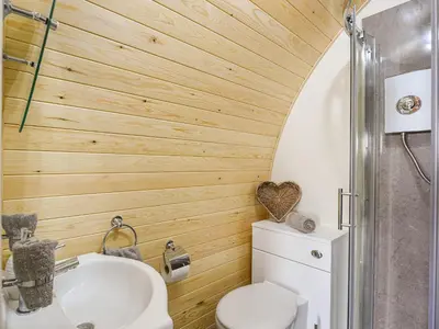 a bathroom with a toilet and a sink at Cae Bitfel - Cottage in Llanwddyn