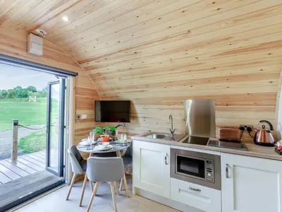 a kitchen with a table in a tiny house at Chestnut Uk36261 in Llanfair Caereinion