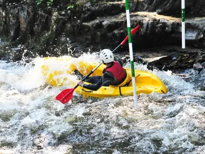 a person is in a raft in a river at Cerniw - Cottage in Aberaeron