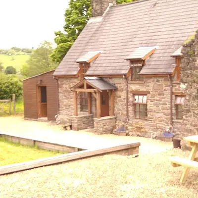 a small stone house with a roof at Wern Ddu, Defynnog - Brecon Beacons in Brecon