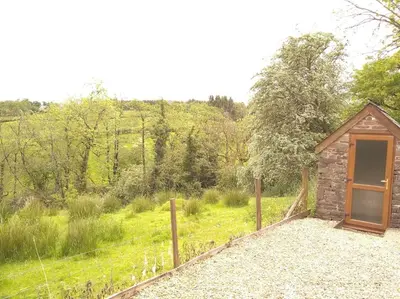 a small building with a door in a field at Wern Ddu, Defynnog - Brecon Beacons in Brecon