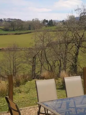 a table and chairs with a view of a field at Wern Ddu, Defynnog - Brecon Beacons in Brecon