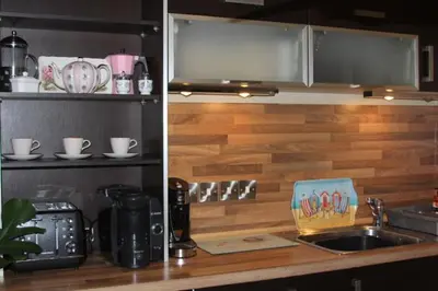 a kitchen with a counter top with a sink and a counter top at Pier View Sea View Apartment Aberystwyth Promenade in Aberystwyth