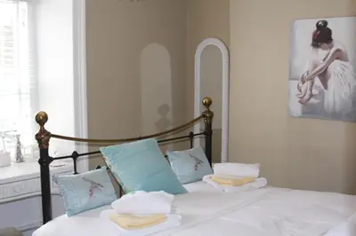a bedroom with a bed with towels on it at Pier View Sea View Apartment Aberystwyth Promenade in Aberystwyth