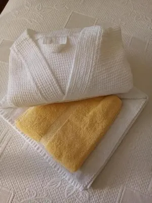 two white towels sitting on top of a table at Pier View Sea View Apartment Aberystwyth Promenade in Aberystwyth