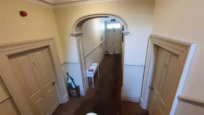 a hallway with an archway in a room with a hallway at Pier View Sea View Apartment Aberystwyth Promenade in Aberystwyth