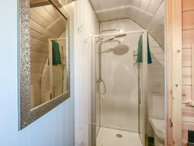 a bathroom with a shower and a mirror at Creyr Glas Pod -Uk41796 in Hirnant