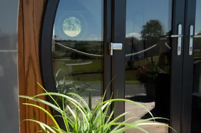 a door with a view of the moon seen through it at Bedwen in Welshpool
