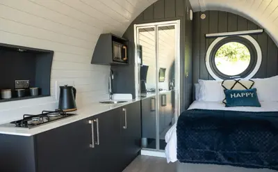 a bedroom with a bed and a counter with a stove at Bedwen in Welshpool