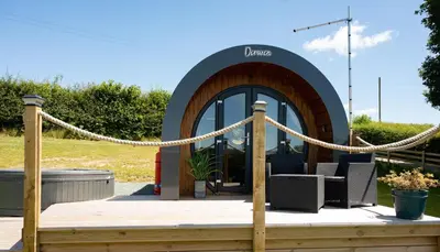 a wooden deck with a rope and a building at Derwen in Welshpool