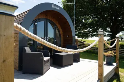 a patio with chairs and a rope in front of a building at Derwen in Welshpool