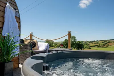 a hot tub on the patio of a house at Derwen in Welshpool