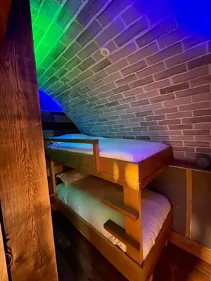 a bench in a room with a brick wall at Rabbits View in Rhayader
