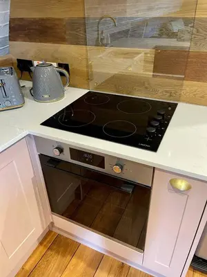 a stove top oven sitting in a kitchen at Rabbits View in Rhayader