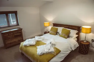 a bedroom with a bed with towels on it at Swallows Rest in Montgomery