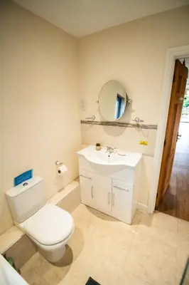 a bathroom with a white toilet and a sink at Caban Nant Ddu in Nantmel