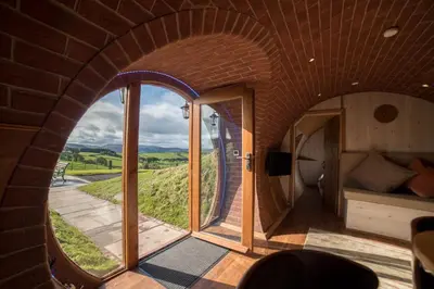 an arched room with a large window in a building at Foxes View in Rhayader