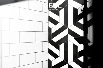 a white tiled wall with a black and white pattern at 5 Bedroom Victorian Town House - Perfect for Contractors and Family Groups in Shrewsbury