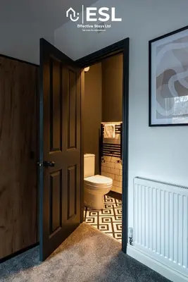 an open door to a bathroom with a toilet at 5 Bedroom Victorian Town House - Perfect for Contractors and Family Groups in Shrewsbury