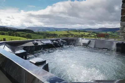 a large pool of water with a bench in it at Badgers View in Rhayader