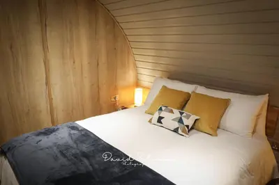 a bed with two pillows on it in a room at Badgers View in Rhayader