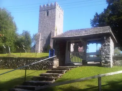 an old stone church with a tower and stairs at Seven Stars- hot tub & garden with fabulous views. in Llandrindod Wells