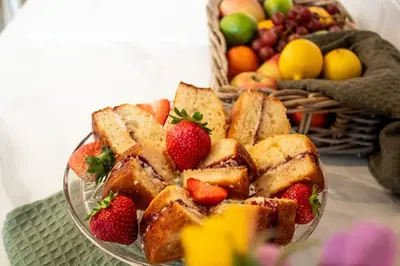 a glass bowl filled with bread and strawberries on a table at Hillside Lodge in Nantmel