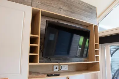 a flat screen tv in a entertainment center at Hillside Lodge in Nantmel