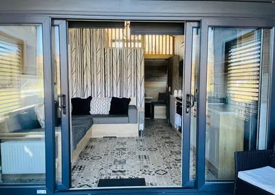 a living room with a couch and a window at Meadow Retreat in Rhayader