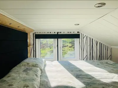 a bedroom with a bed in front of a window at Oak Tree View in Nantmel