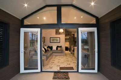 a room with a large glass door with a living room at Oak Tree View in Nantmel
