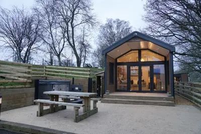 a small shed with a picnic table and a bench at Oak Tree View in Nantmel