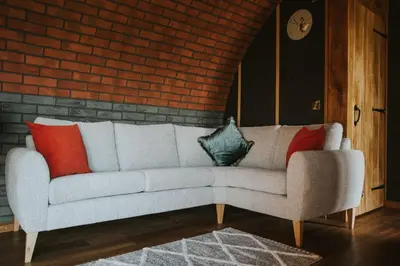 a living room with a couch with pillows on it at Otters View in Rhayader