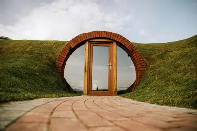 a door in the middle of a grassy hill at Otters View in Rhayader